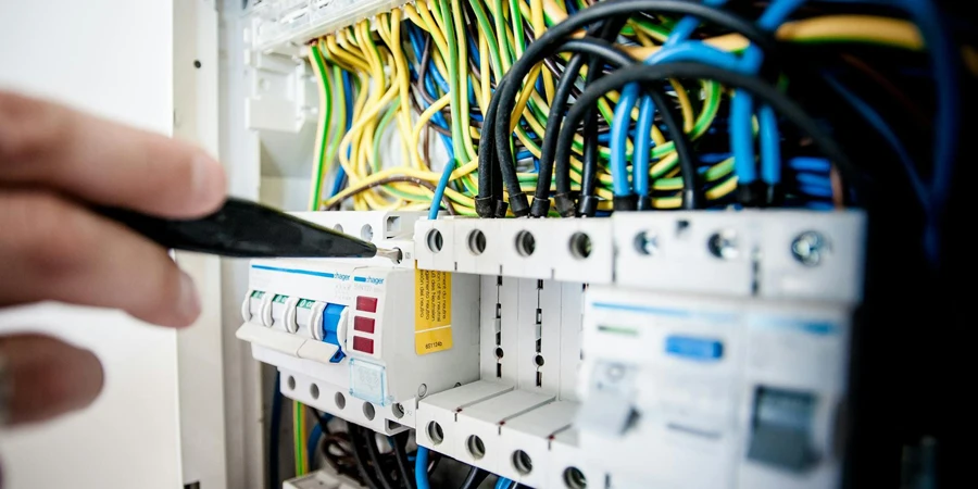 Electrician Fixing an Opened Switchboard