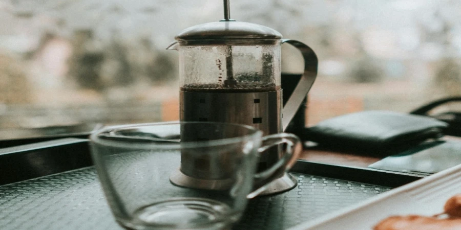 Empty Cup Beside Coffee Press