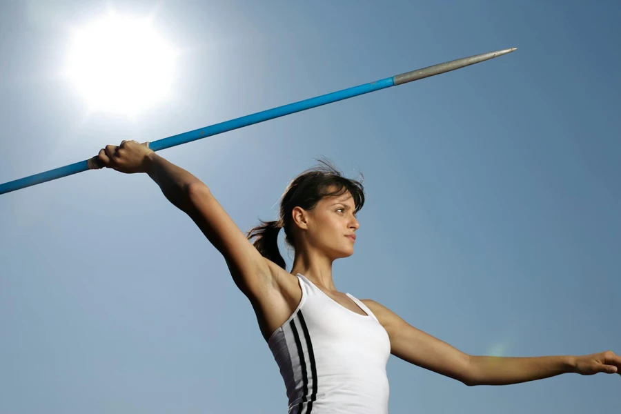 Female Athlete throwing a blue headwind javelin