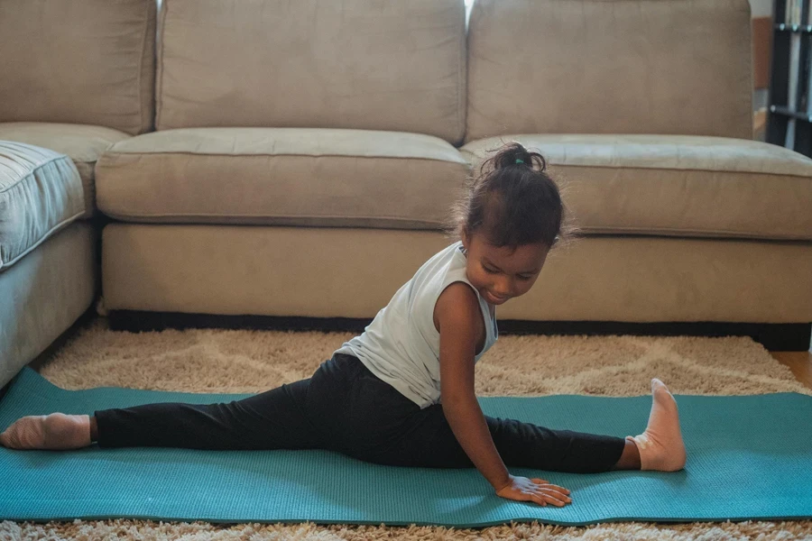 Focused girl doing leg split