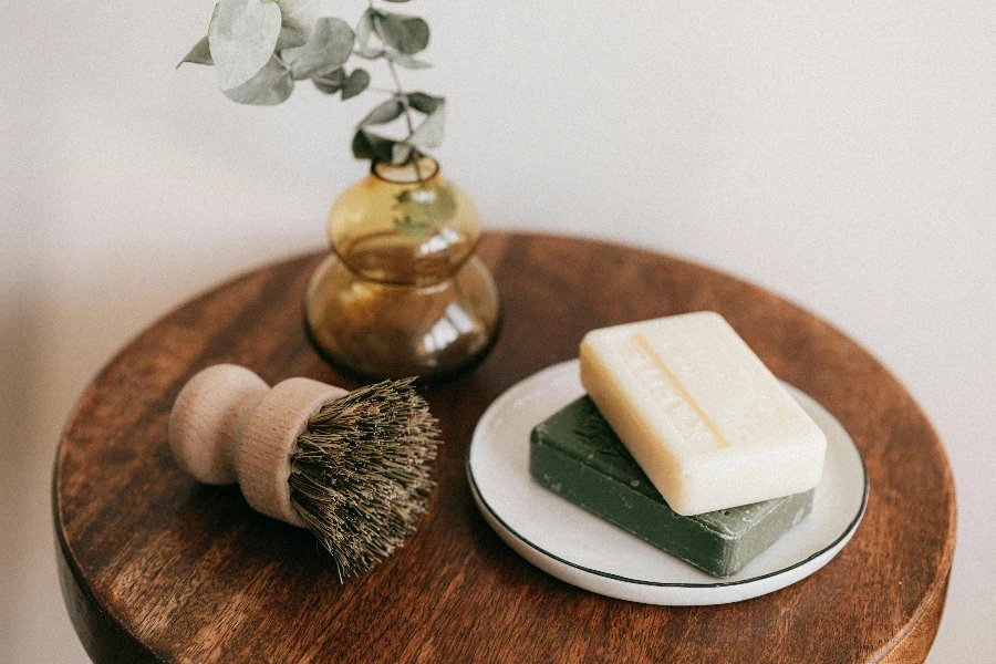 handmade soaps and natural brush on wooden table