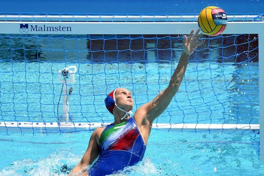 Goalkeeper defending a water polo goal post