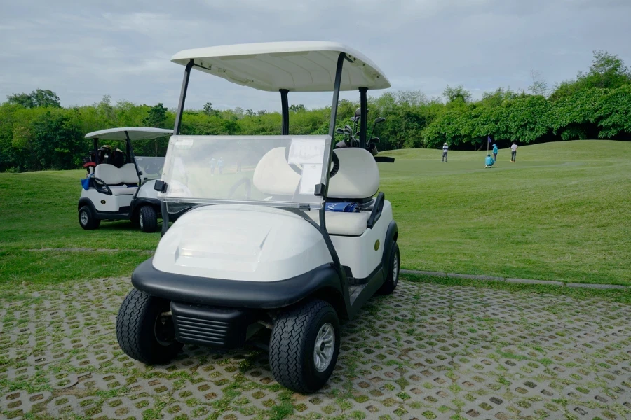 Golfcar-on-beautiful-golf-course-in-the-evening-golf-course-with-fresh-green-grass-field-and-cloud-sky