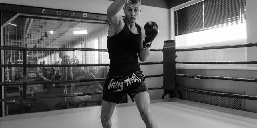 Grayscale Photo of a Man Doing Shadow Boxing by Tima Miroshnichenko