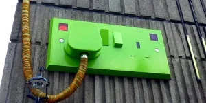 Green Rectangular Corded Machine on Grey Wall during Daytime