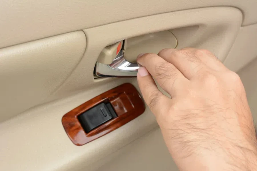 Hand pulling car interior door handle, opening car door