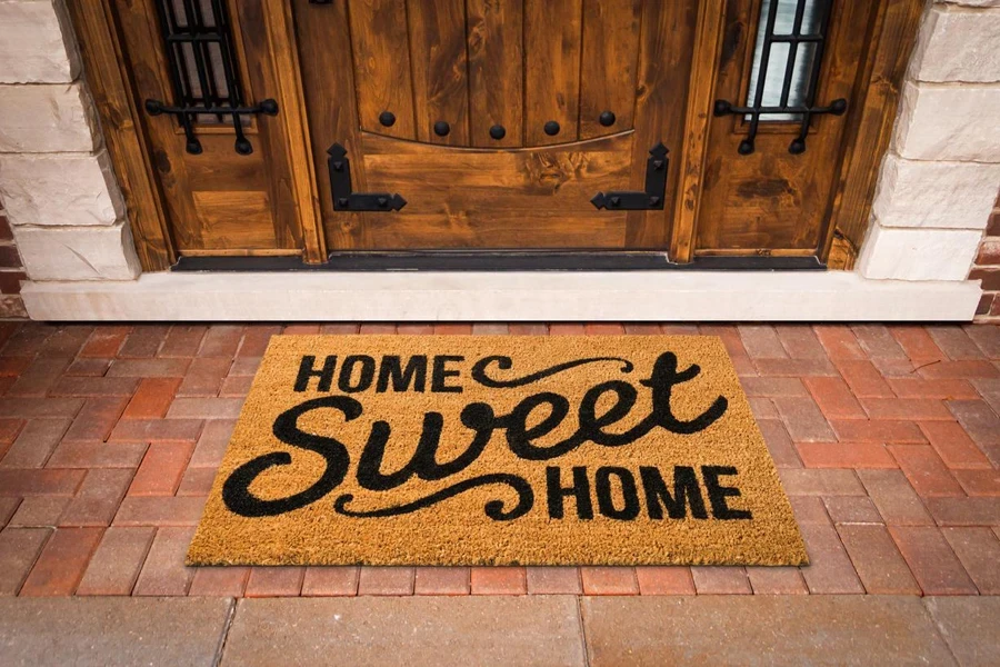 Home Sweet Home Welcome Mat At Custom Front Door of House.