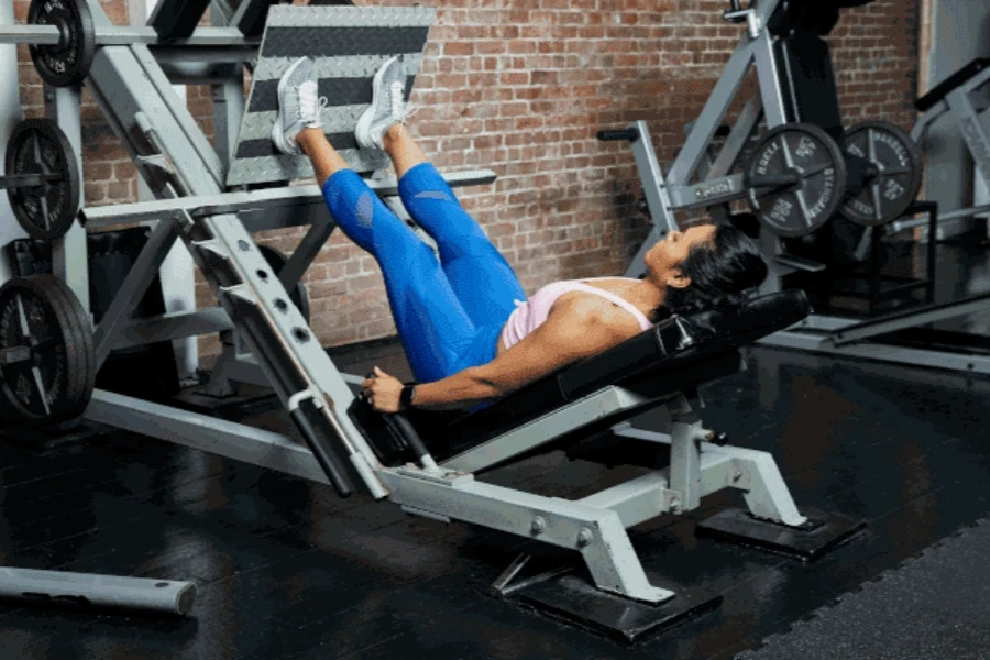 Lady leg pressing in a gym