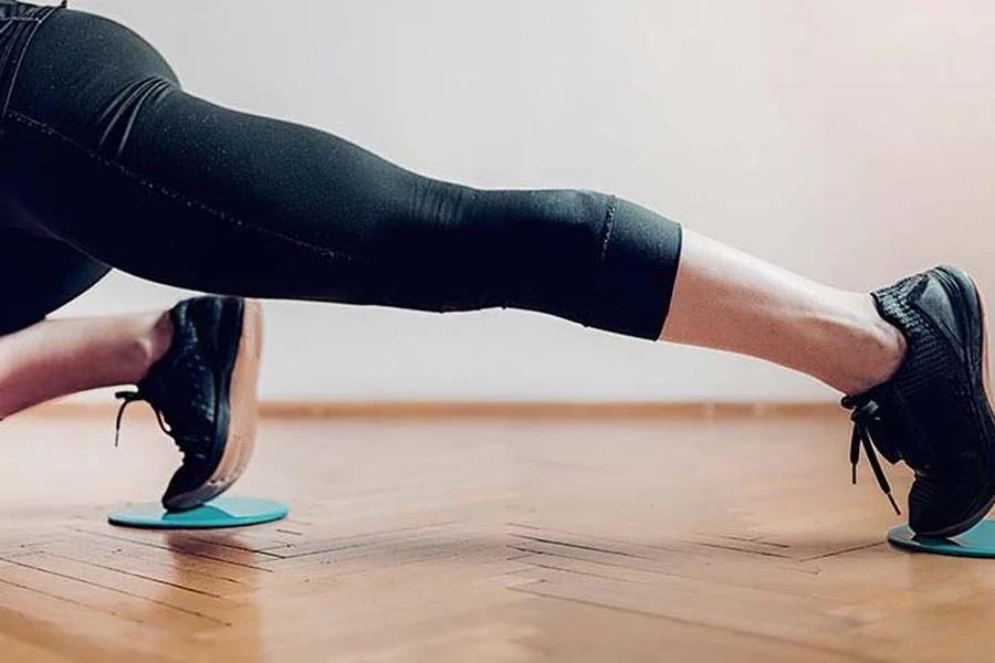 Lady using a pair of green core sliders