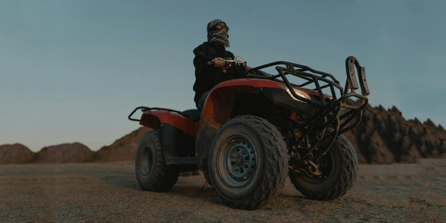 Low Angle Shot of a Man Riding an ATV on the Desert