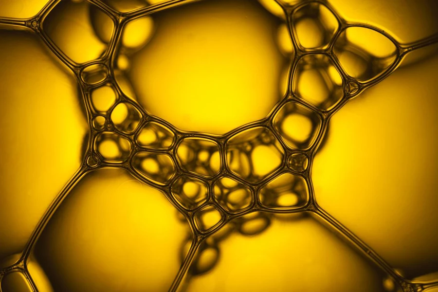 Macro photography of soap bubbles. Yellow backlight