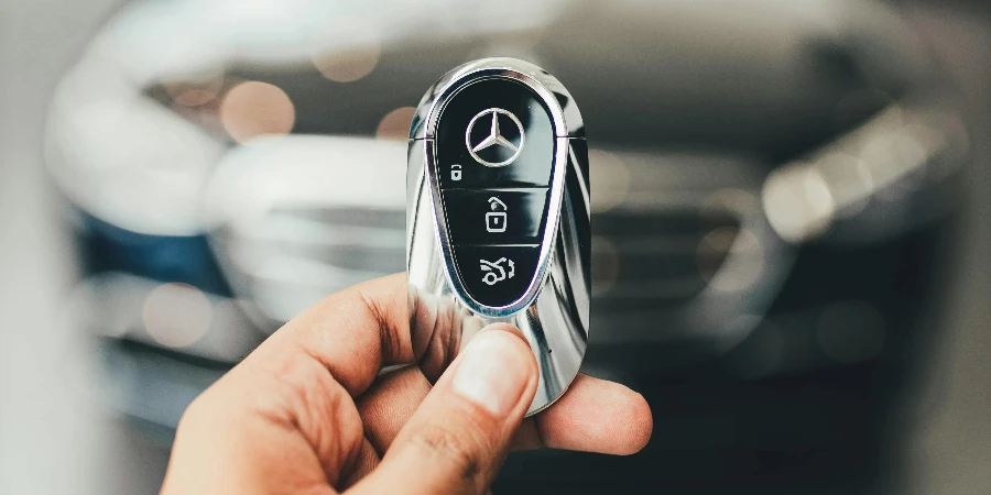 Man Hand Holding New Mercedes Car Key by Mohit Hambiria