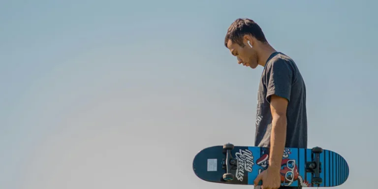 Man Holding A Skateboard