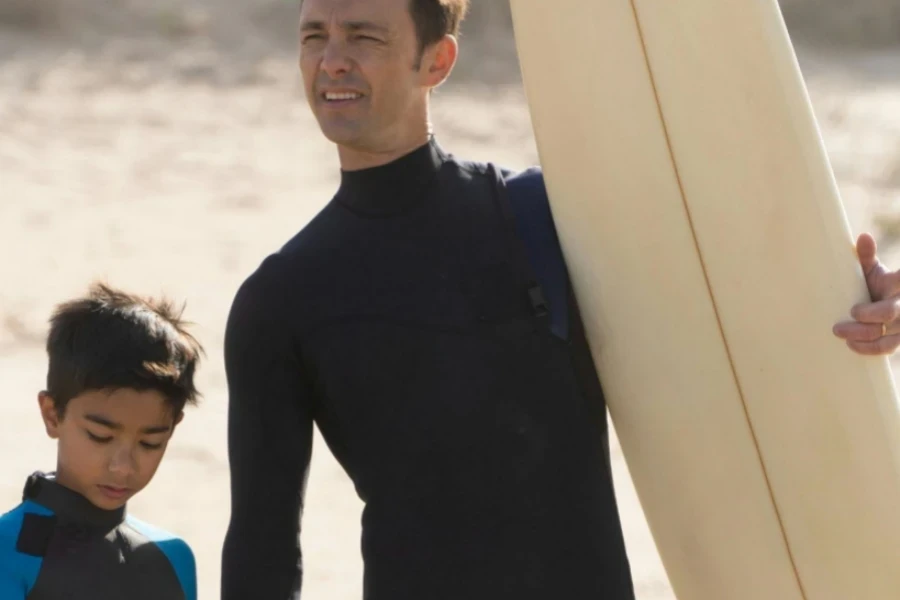 Man Holding the Hand of a Boy at the Beach