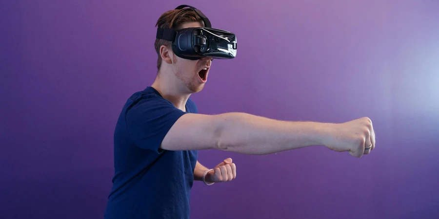 Man Punching in the Air while in VR Goggles