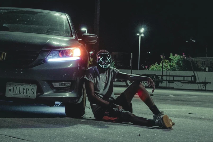 Man Sitting Beside Car