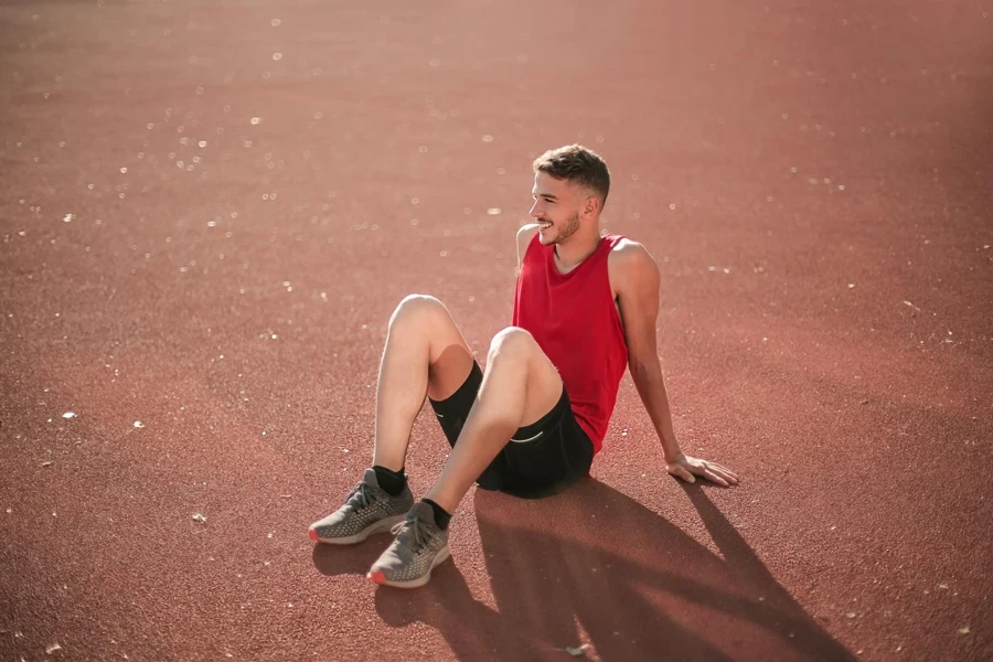 Man Sitting on Maroon Surface