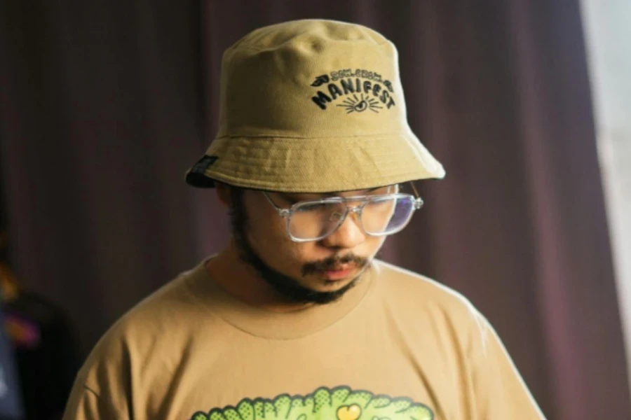 Man Standing in Hat and T-shirt