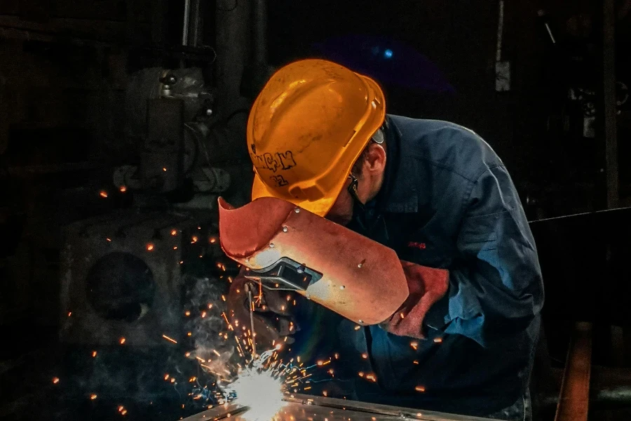 Man Welding on Gray Metal Sheet