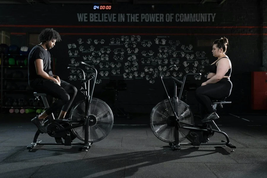 Man and Woman Exercising Using a Stationary Bicycle