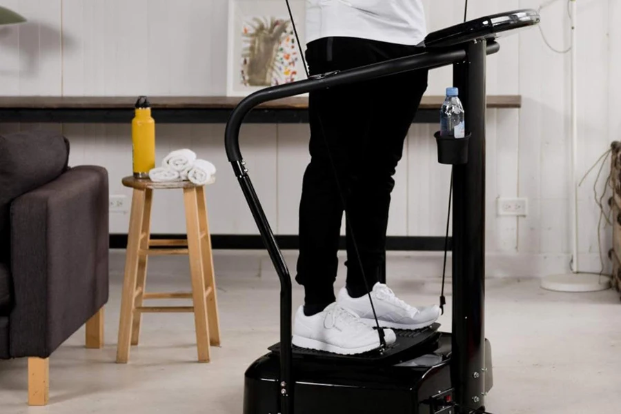 Man doing stand-up exercises on a vibration plate