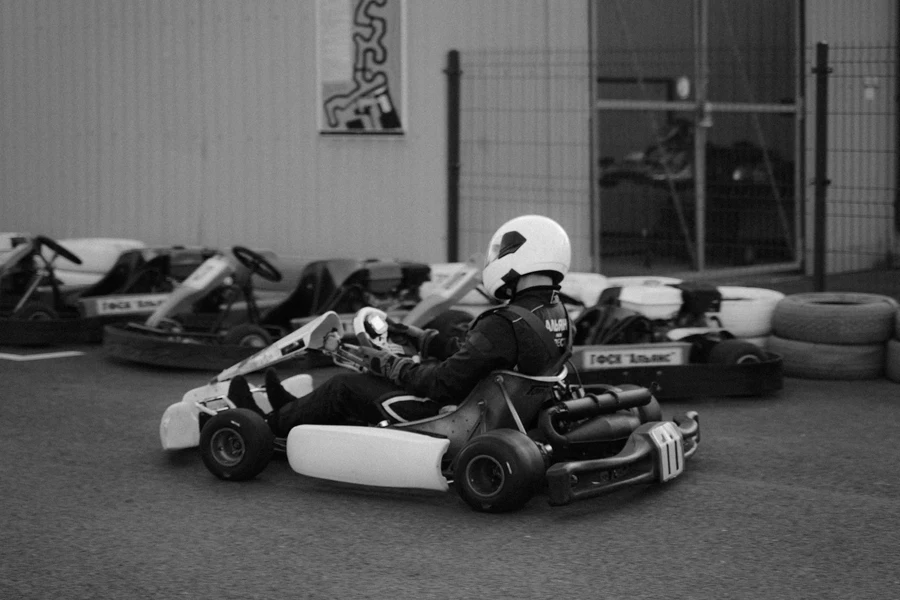 Man in White Helmet Riding on Go Kart