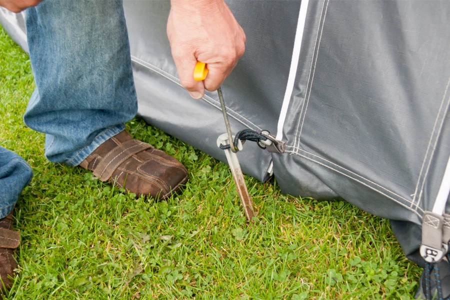 Man installing a high-quality tent peg