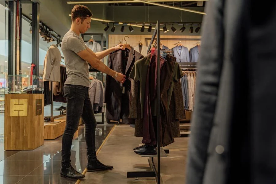 Man looking at a jacket in clothes store