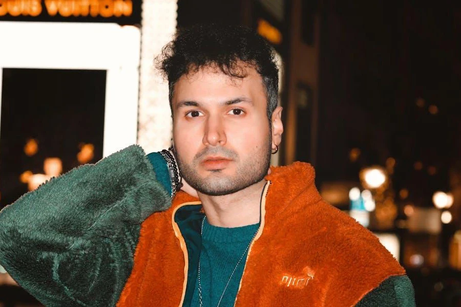 Man posing in a multi-colored thick-pile fleece jacket