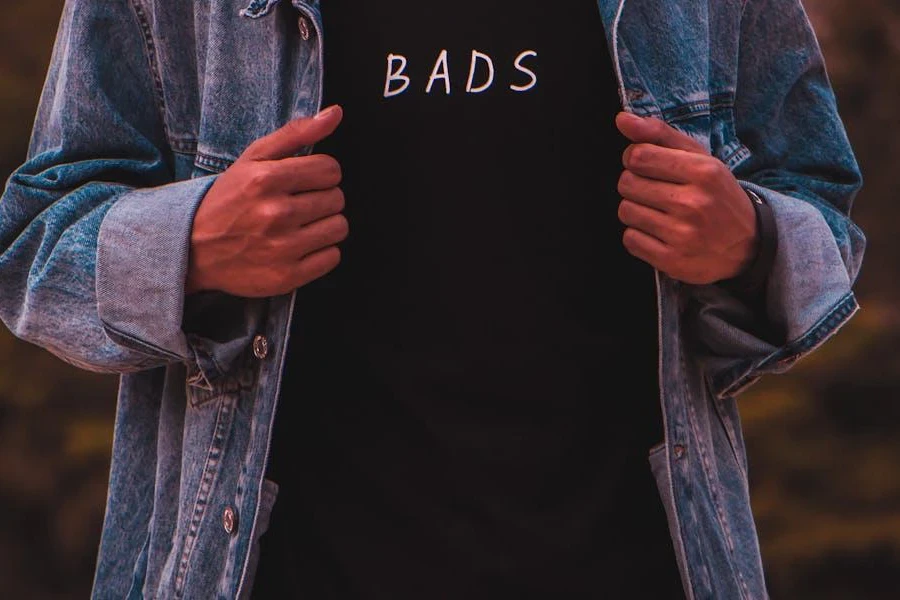 Man posing stylishly in a denim jacket