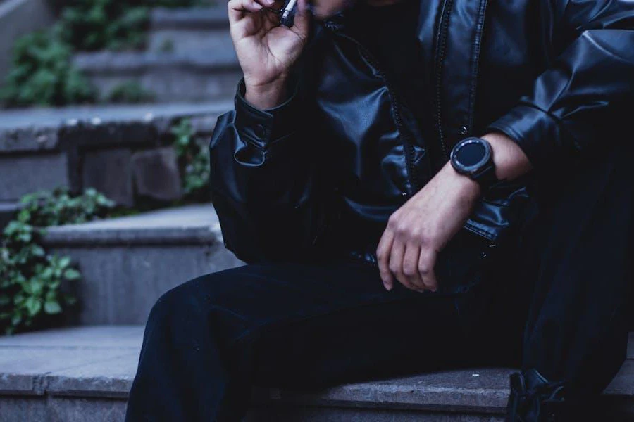 Man resting on a staircase in a leather jacket