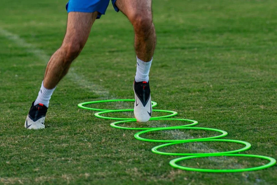 Man training with green agility rings
