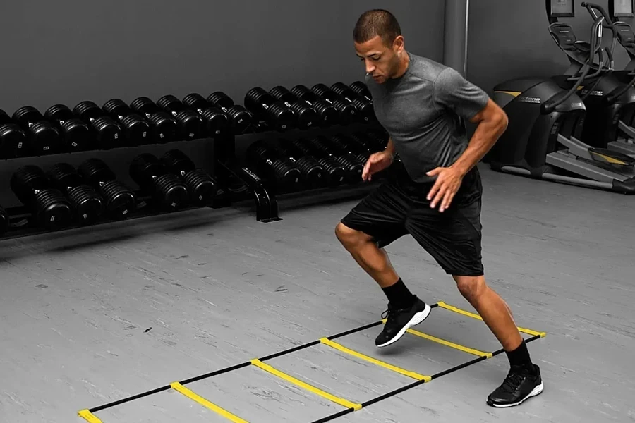 Man using an agility ladder in a gym