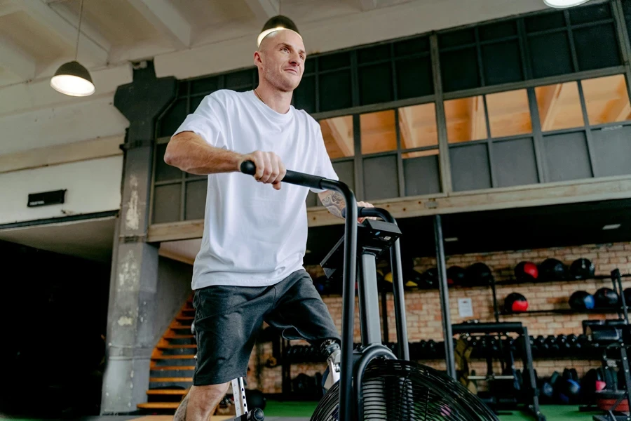 Man with Prosthetic Leg Exercising on an Exercise Bike in a Gym