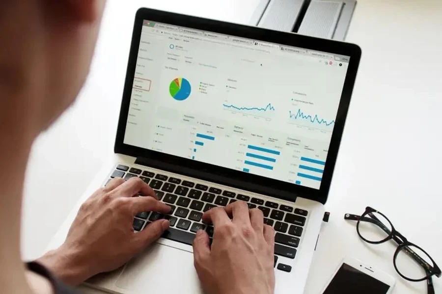 Man working on sales data at a workstation