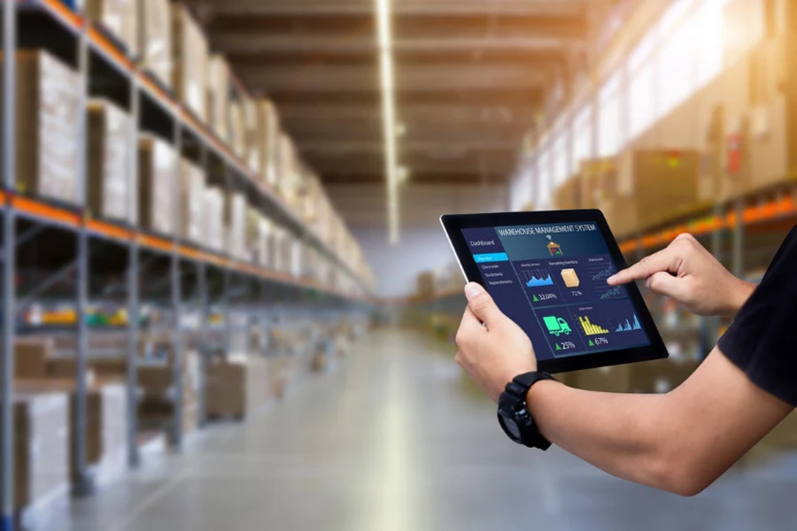 Manager using warehouse management software on a tablet
