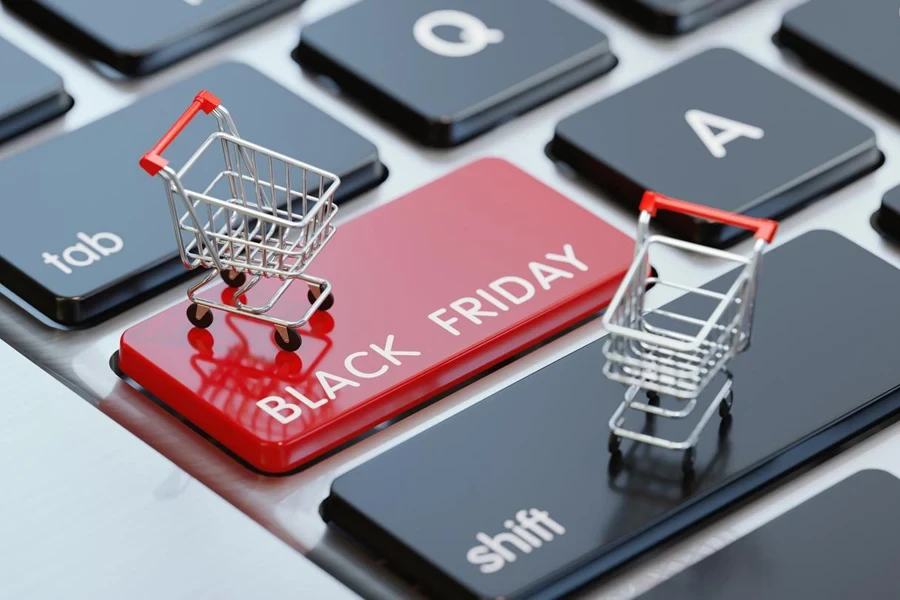 Modern computer keyboard with a shopping carts and a red Black Friday button. 