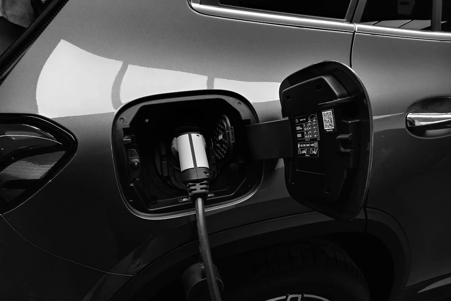 Monochrome Photo of Hybrid Car charging