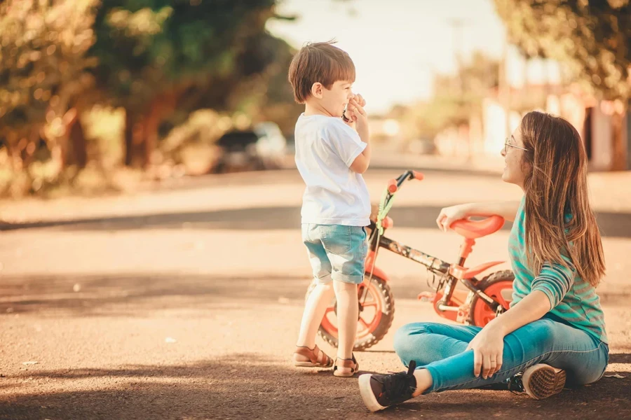 Mother and Son Playing with a Tricycle on the Street