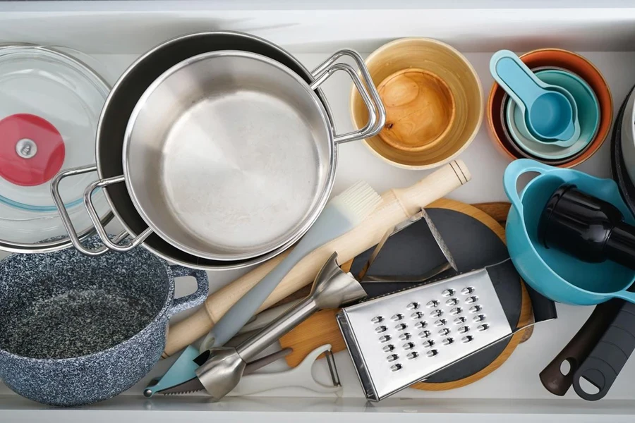 Open drawer with different utensils in kitchen