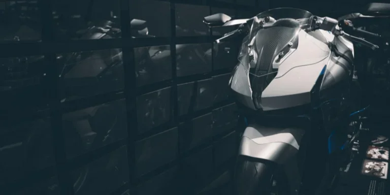 Parked Sports Bike beside Glass Wall