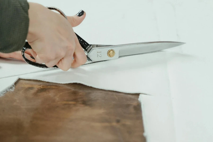 Person Holding Silver Bread Knife