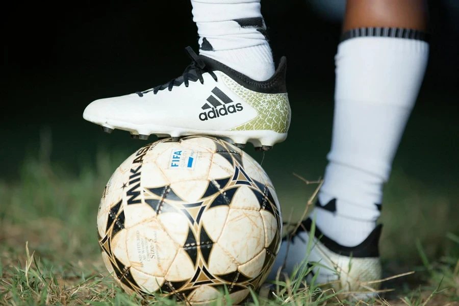 Person Stepping on a Soccer Ball