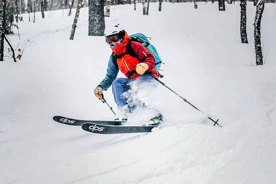 Person enjoying backcountry skiing while avoiding trees