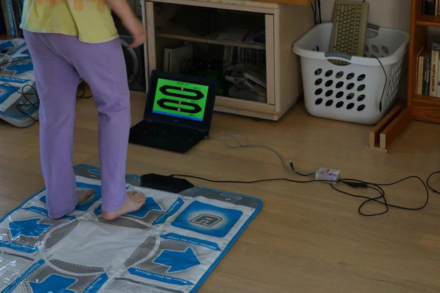 Person hooking up a dance mat to a laptop