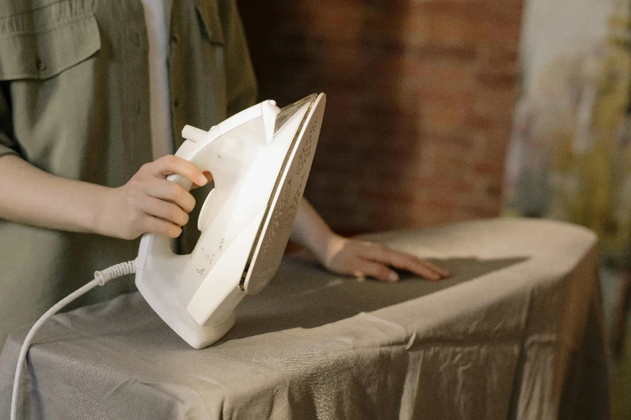 Person in Gray Dress Shirt Holding White Book