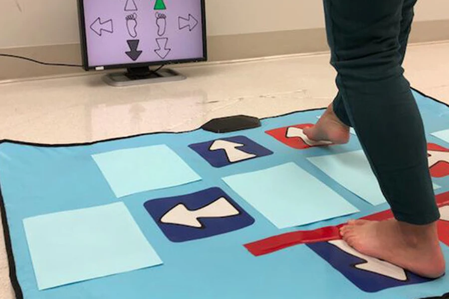 Person playing a game on a blue dance mat