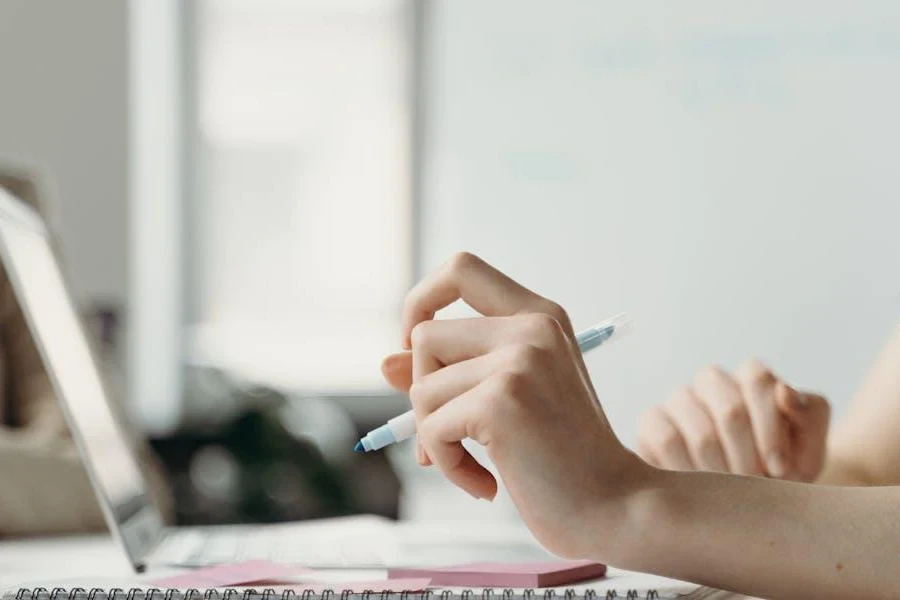 Person typing while holding a stylus