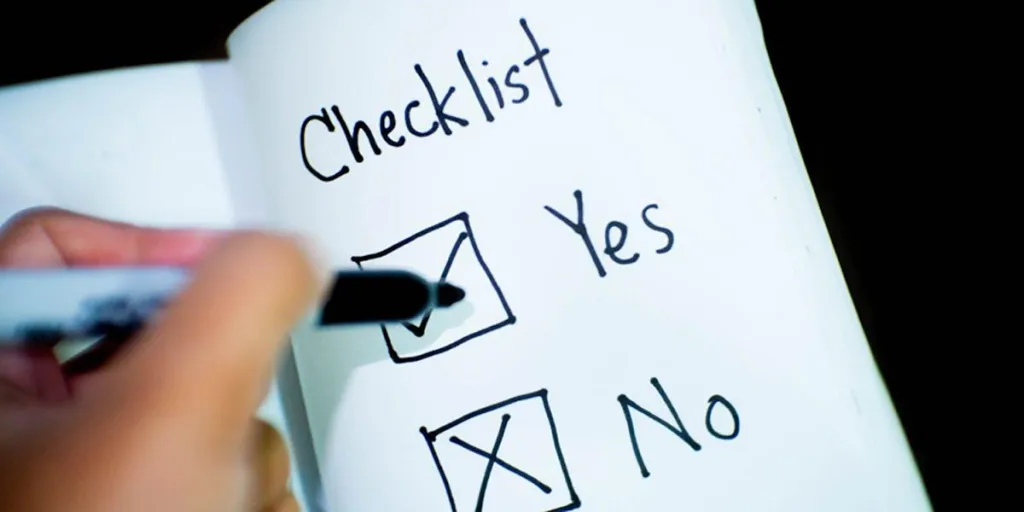 Person using a checklist on a book