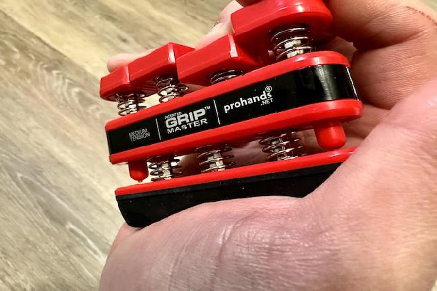 Person using a red article grip trainer